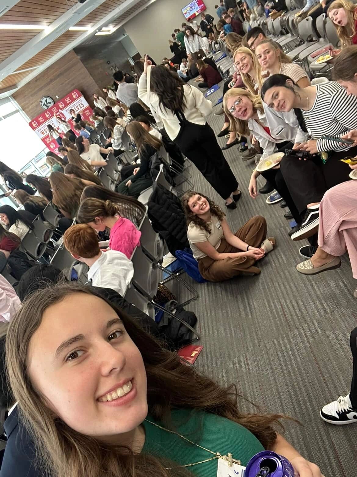 South Dakota FBLA: members taking a group selfie in an auditorium