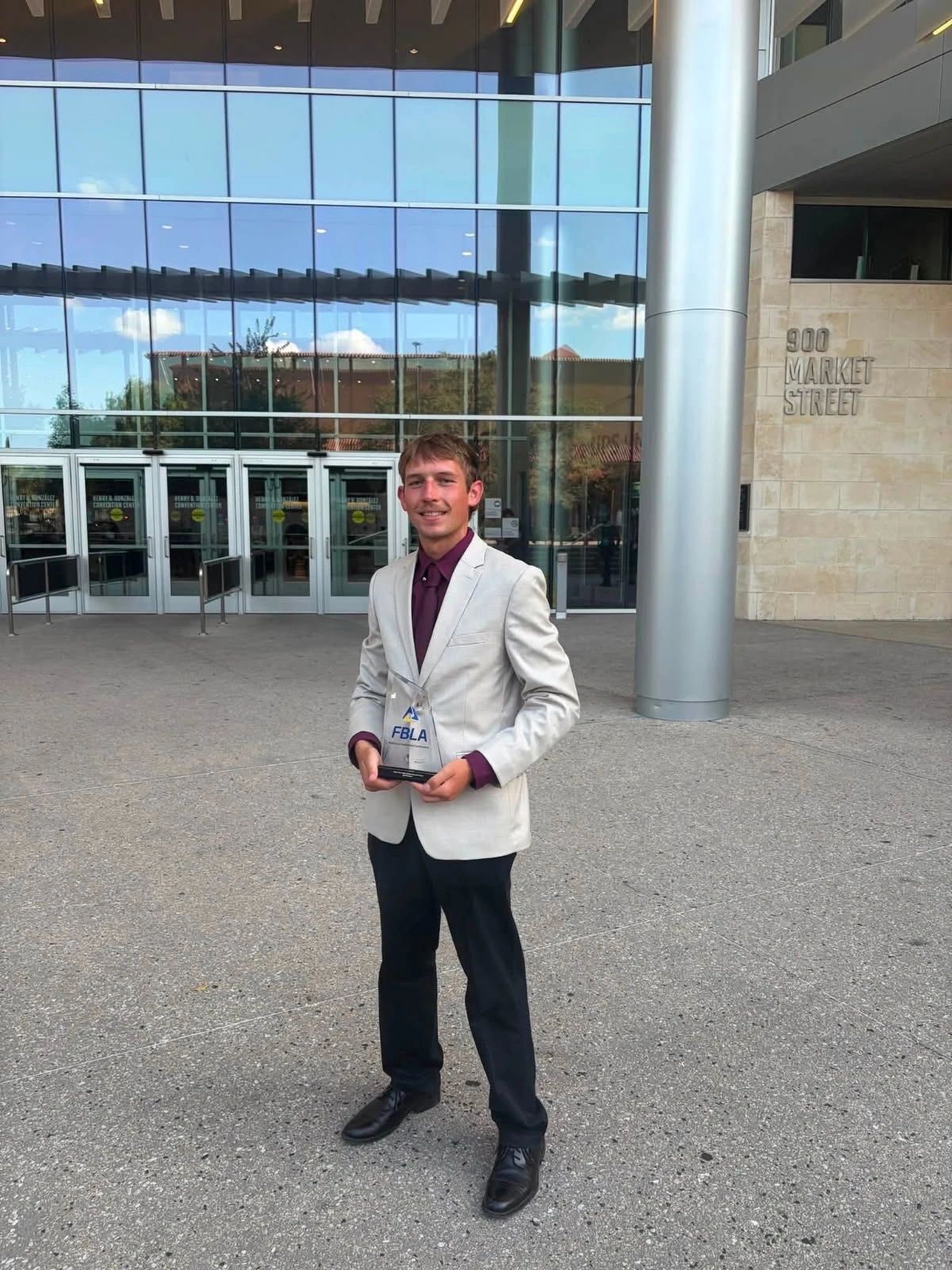 South Dakota FBLA member in professional dress outside a conference building